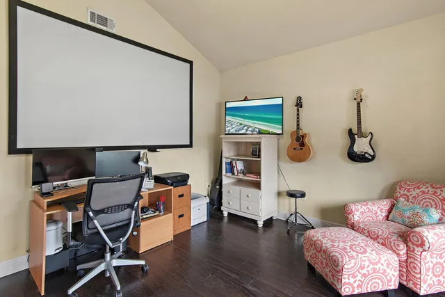 a reading room with furniture and wooden floor