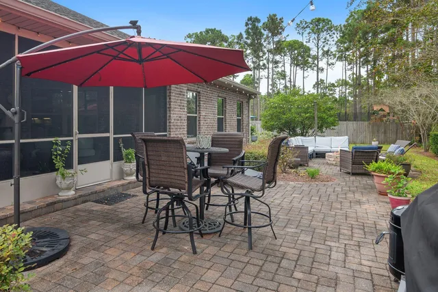 a roof deck with table and chairs under an umbrella