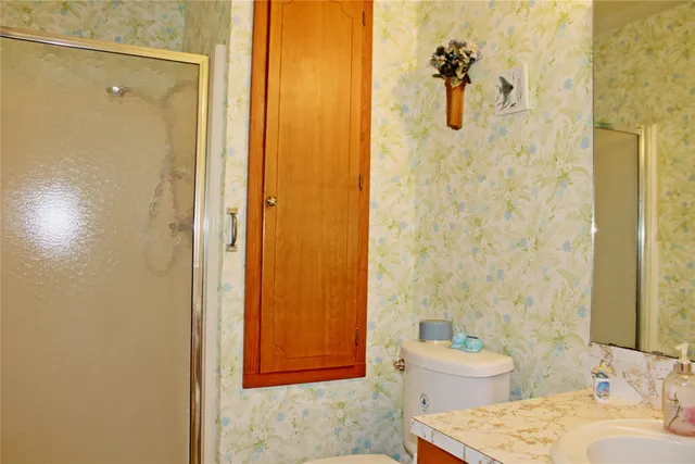 a bathroom with a sink toilet and shower