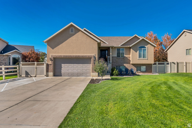 1071 Jamie-Matt Circle Layton, UT 84041 - Photo 25 of 28 Single story home with a gate, stucco siding, concrete driveway, and brick siding