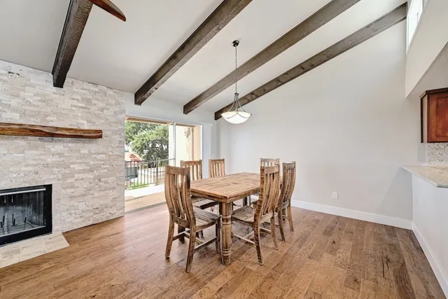 a view of a dining room with furniture and wooden floor