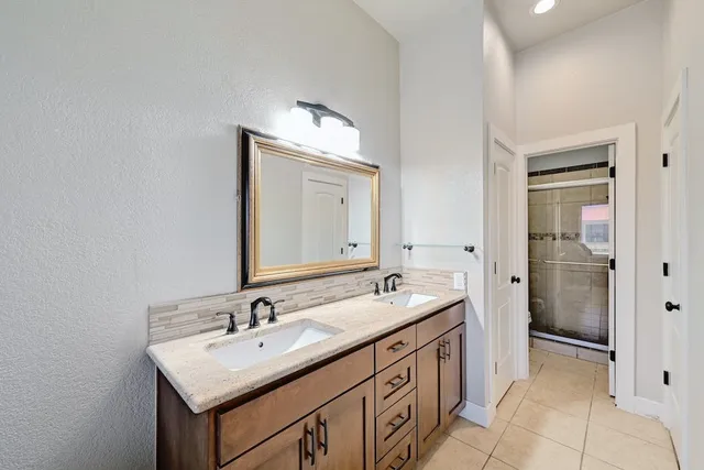 a bathroom with a sink double vanity and a mirror