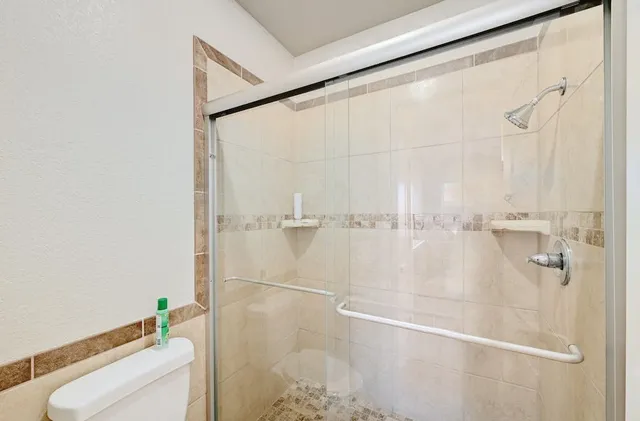 a bathroom with a shower and a toilet