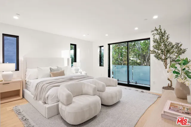 a bedroom with a large bed and a large window