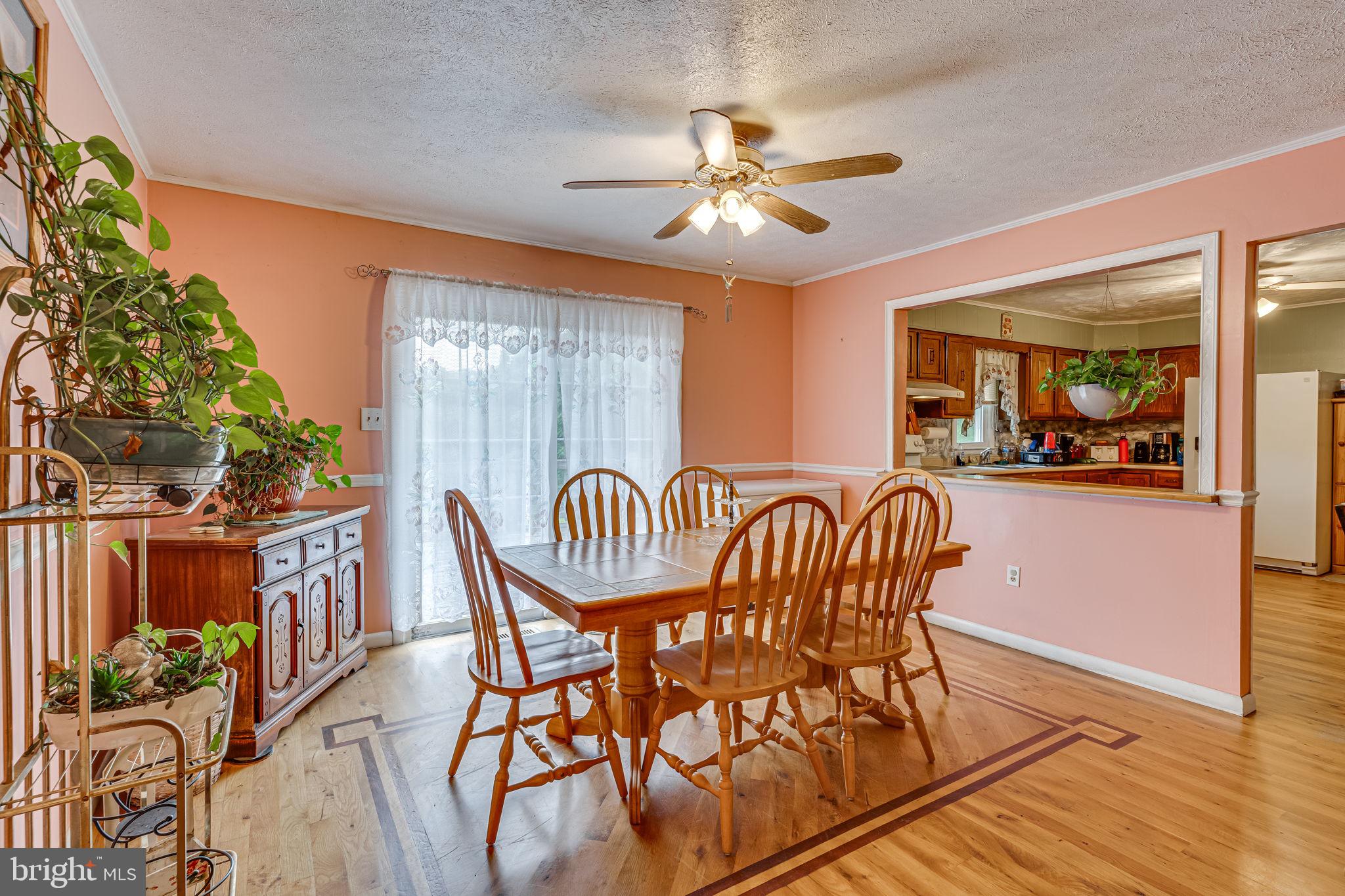 5865 Mackall Road St. Leonard, MD 20685 - Photo 6 of 24 a view of a dining room with furniture window and wooden floor