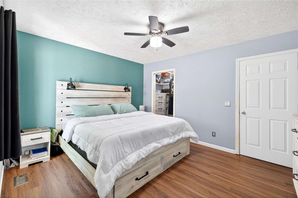 386 Ridgewood Drive Pendergrass, GA 30567 - Photo 25 of 50 a bedroom with a bed and a ceiling fan