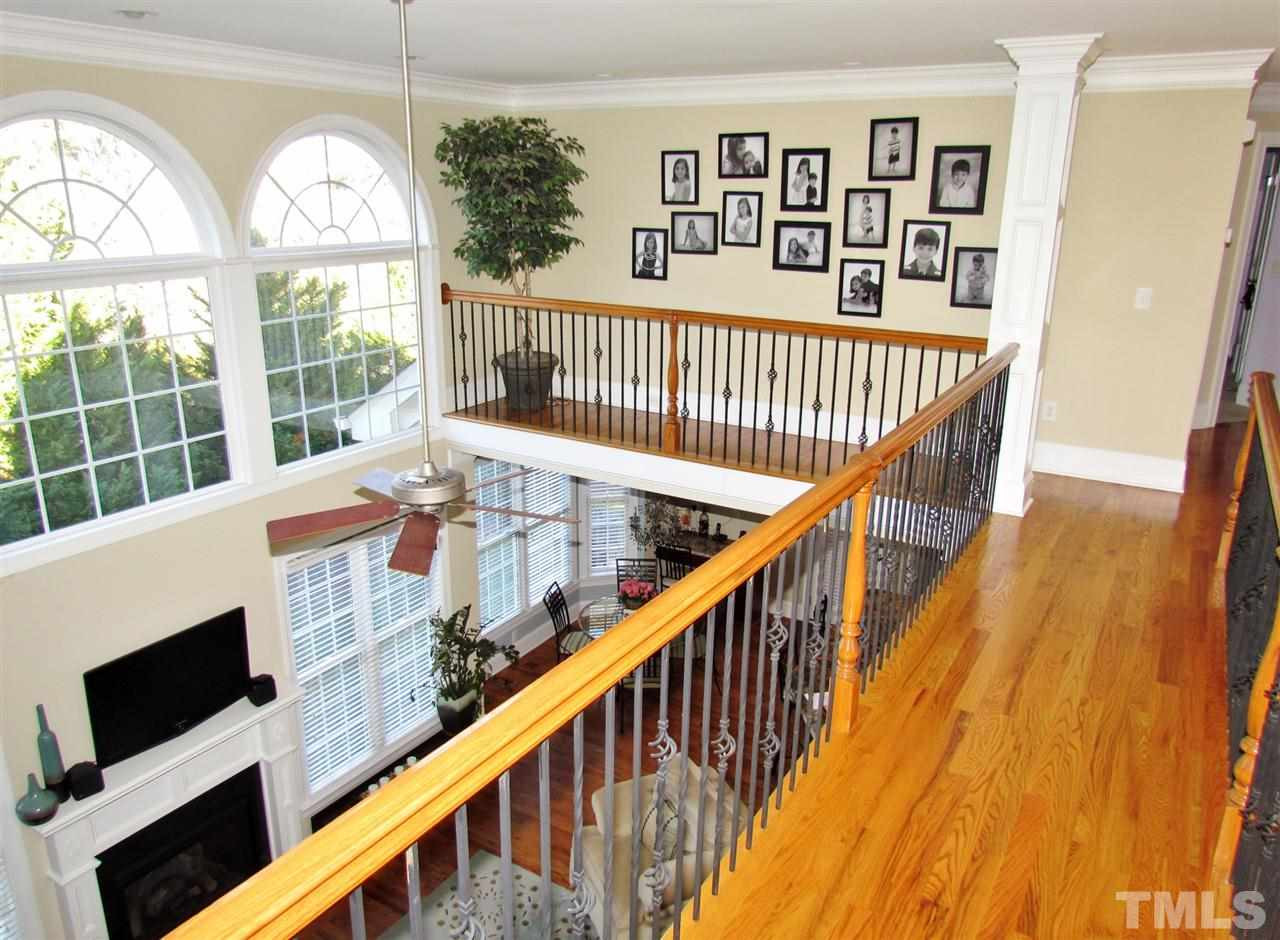 3810 Congeniality Way Raleigh, NC 27613 - Photo 22 of 25 Looking down to the relaxing family room! Note the finished in place hardwood flooring. View from catwalk to guest BDR