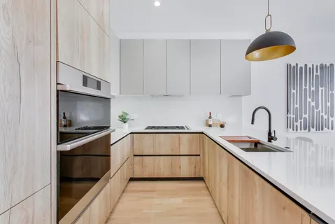 a kitchen with stainless steel appliances a stove sink and cabinets