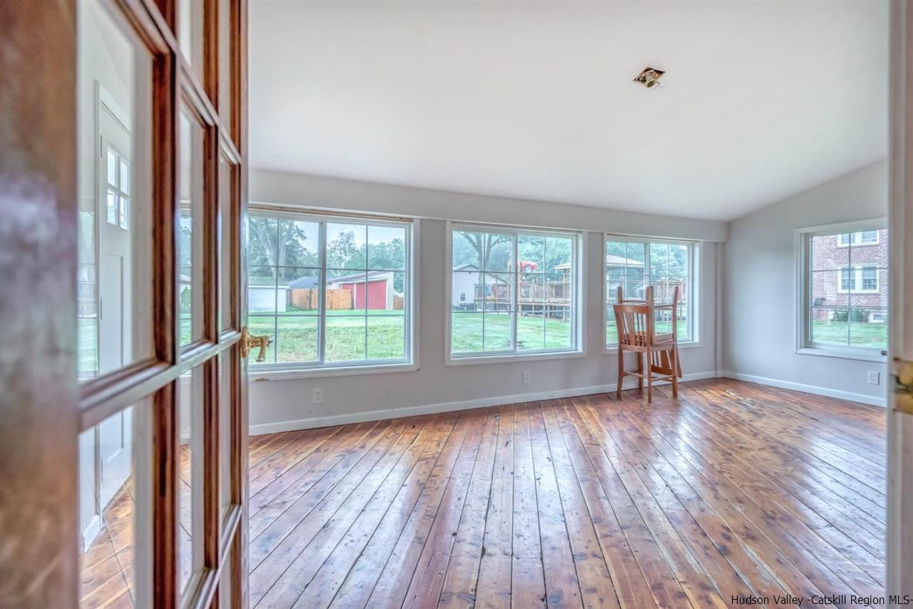 23 Spaulding Lane Saugerties, NY 12477 - Photo 11 of 35 an empty room with wooden floor and windows