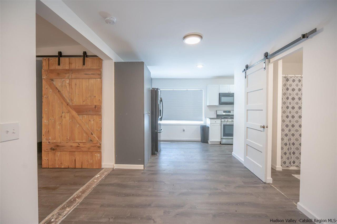 23 Spaulding Lane Saugerties, NY 12477 - Photo 19 of 35 a view of a kitchen with white cabinets and wooden floor
