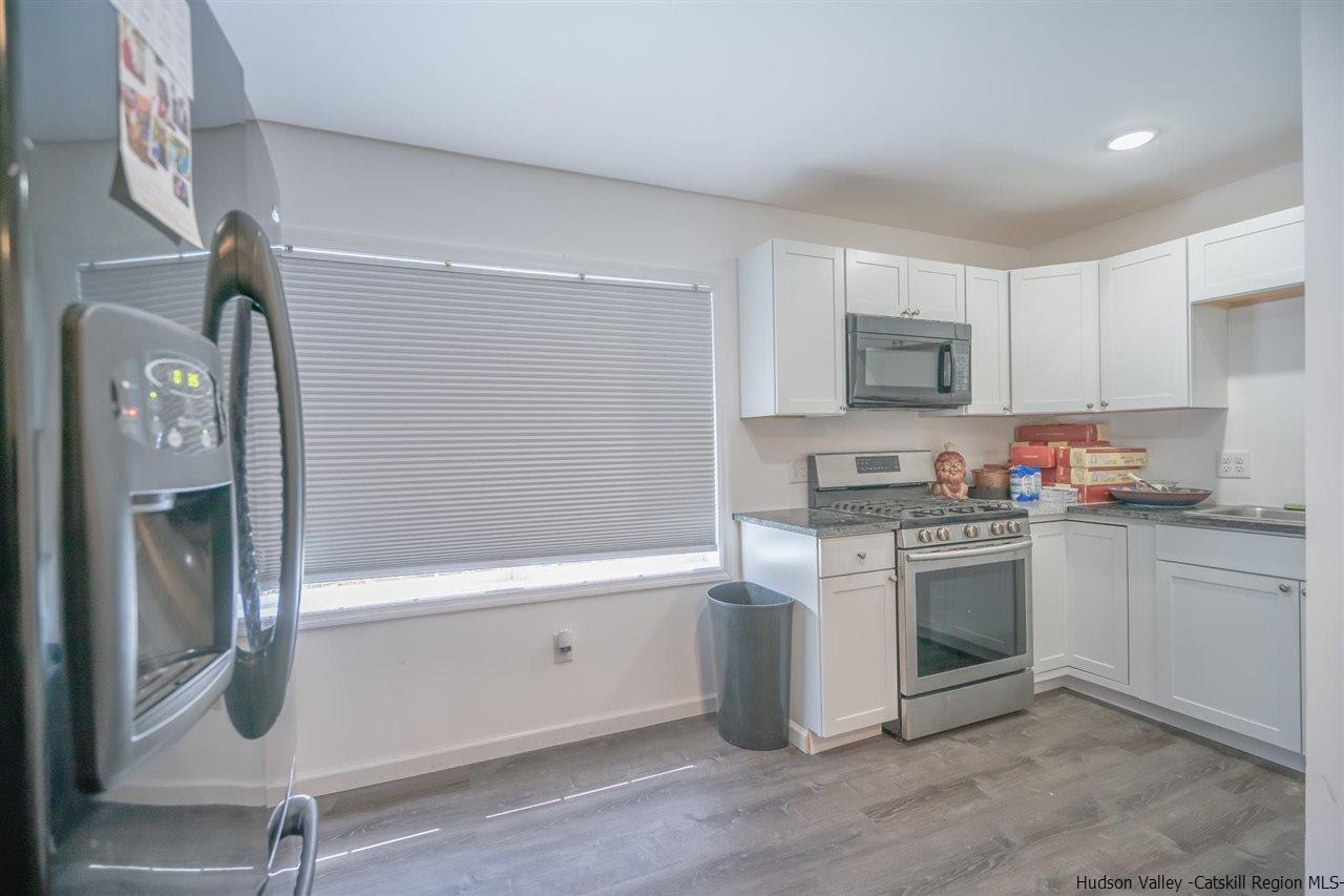 23 Spaulding Lane Saugerties, NY 12477 - Photo 20 of 35 a kitchen with stainless steel appliances granite countertop a stove a sink and a refrigerator