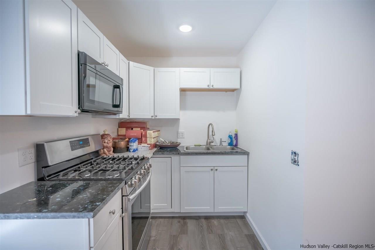 23 Spaulding Lane Saugerties, NY 12477 - Photo 21 of 35 a kitchen with stainless steel appliances granite countertop a sink stove and cabinets