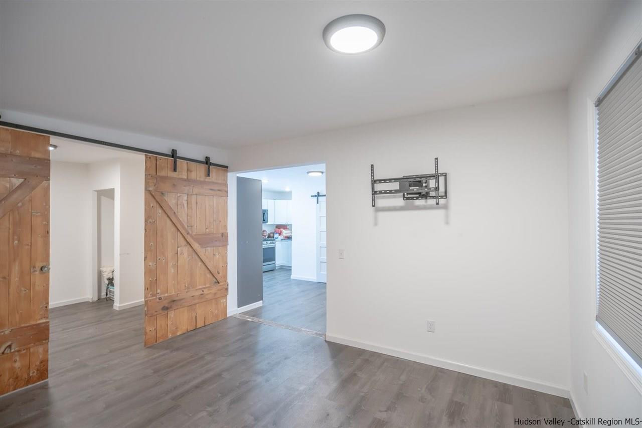 23 Spaulding Lane Saugerties, NY 12477 - Photo 23 of 35 an empty room with wooden floor and stairs