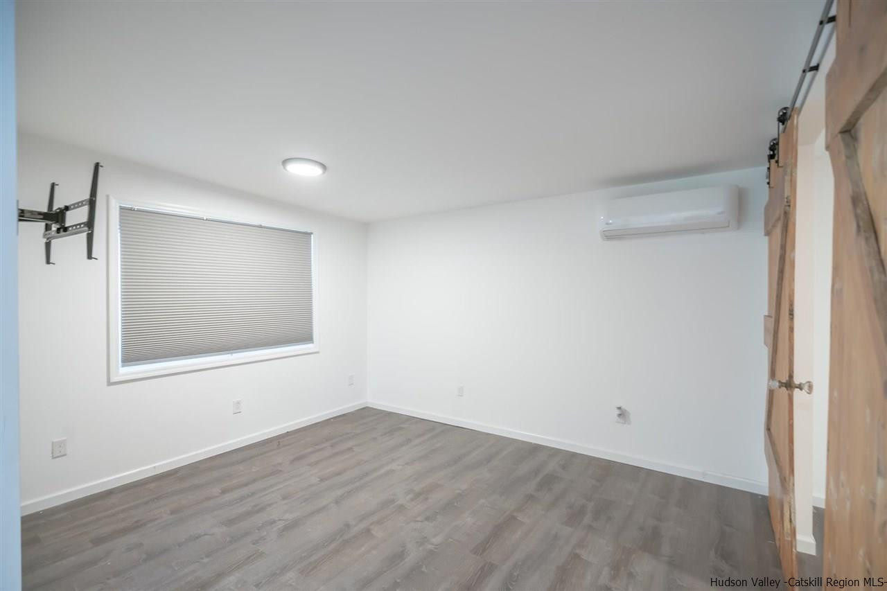 23 Spaulding Lane Saugerties, NY 12477 - Photo 25 of 35 a view of an empty room with wooden floor and a window
