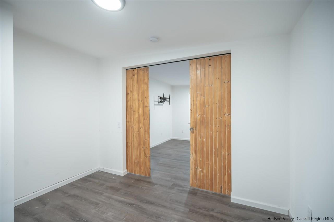 23 Spaulding Lane Saugerties, NY 12477 - Photo 27 of 35 a view of an empty room with wooden floor