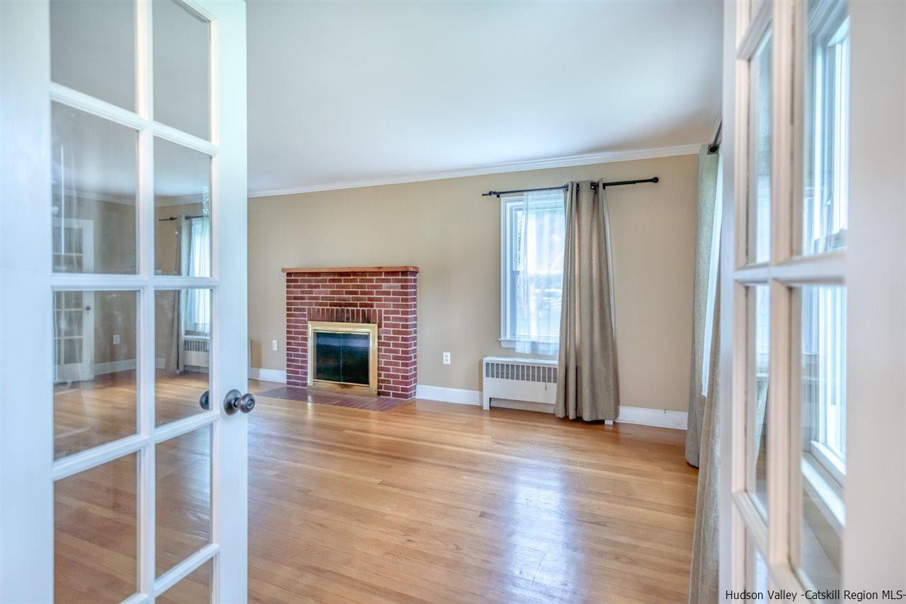 23 Spaulding Lane Saugerties, NY 12477 - Photo 3 of 35 a view of a livingroom with wooden floor and a fireplace