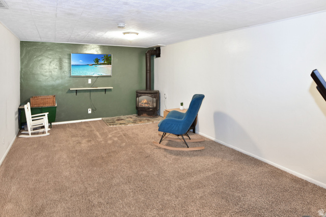 315 Park Street Inkom, ID 83245 - Photo 19 of 28 Spacious room featuring broadloom carpeting and a built-in wood-burning stove with a protective hearth