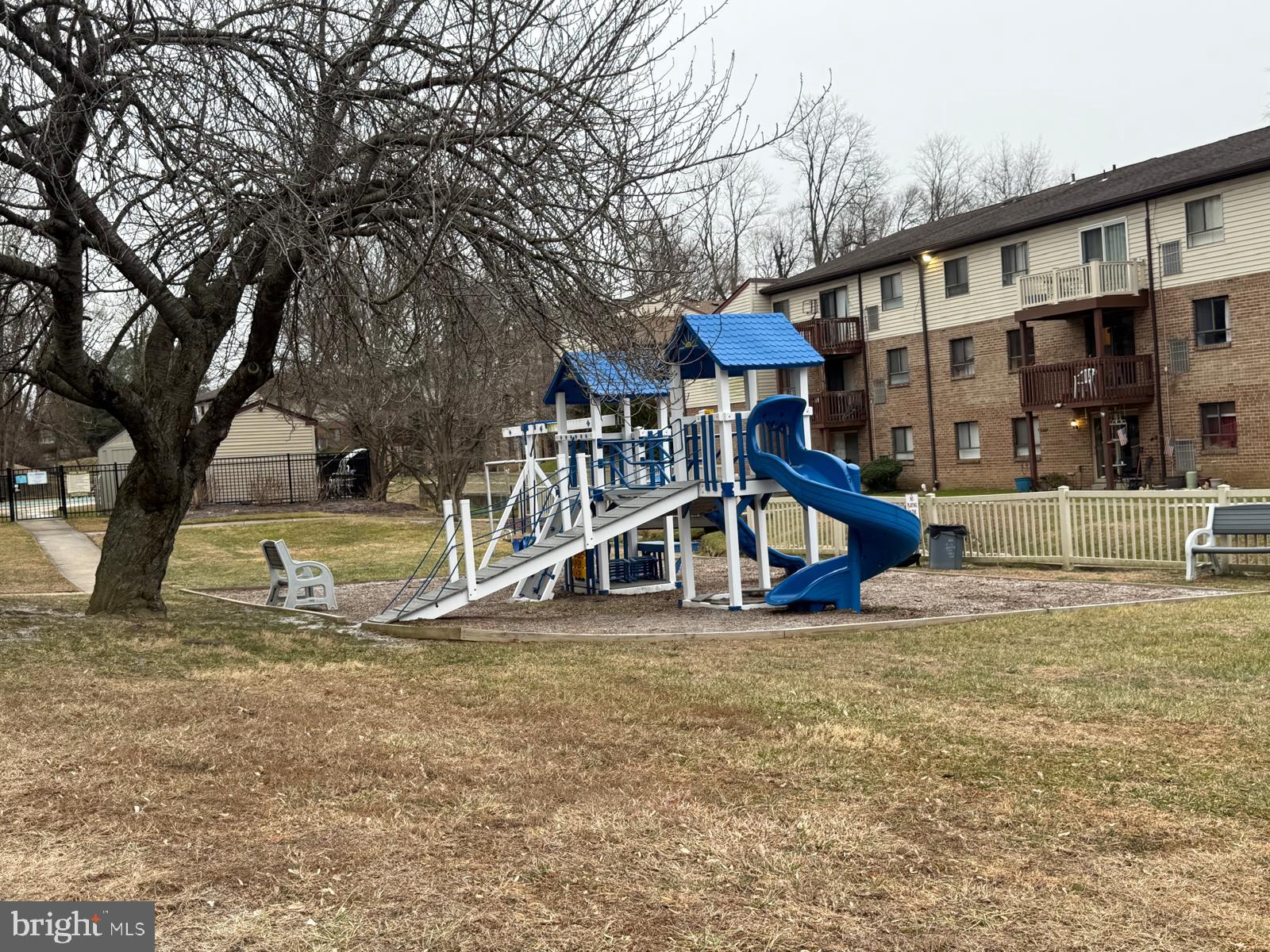 280 Bridgewater Road, Unit D10 Brookhaven, PA 19015 - Photo 12 of 12 a view of a house with large trees and a yard