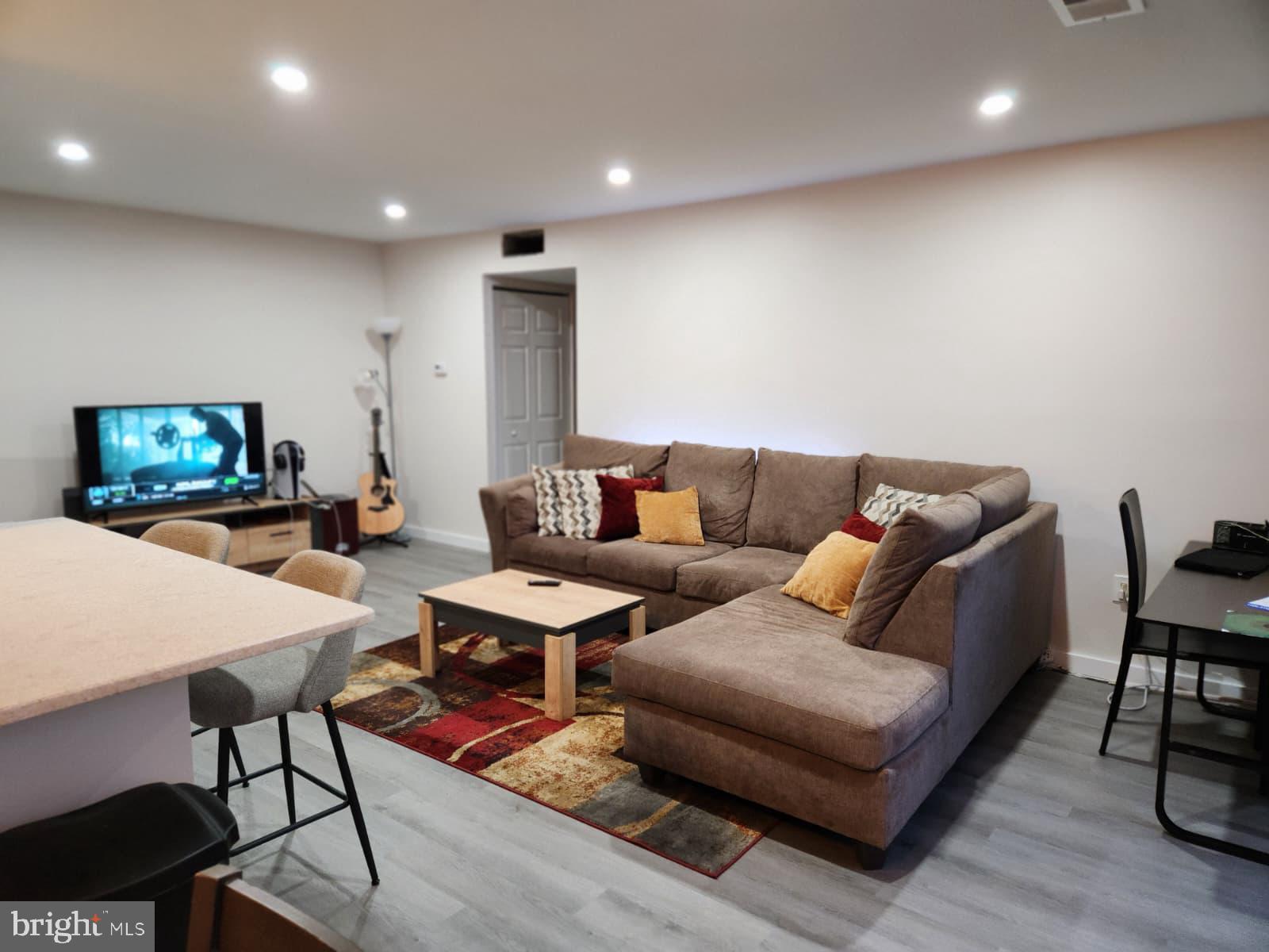 280 Bridgewater Road, Unit D10 Brookhaven, PA 19015 - Photo 5 of 12 a living room with furniture and a wooden floor