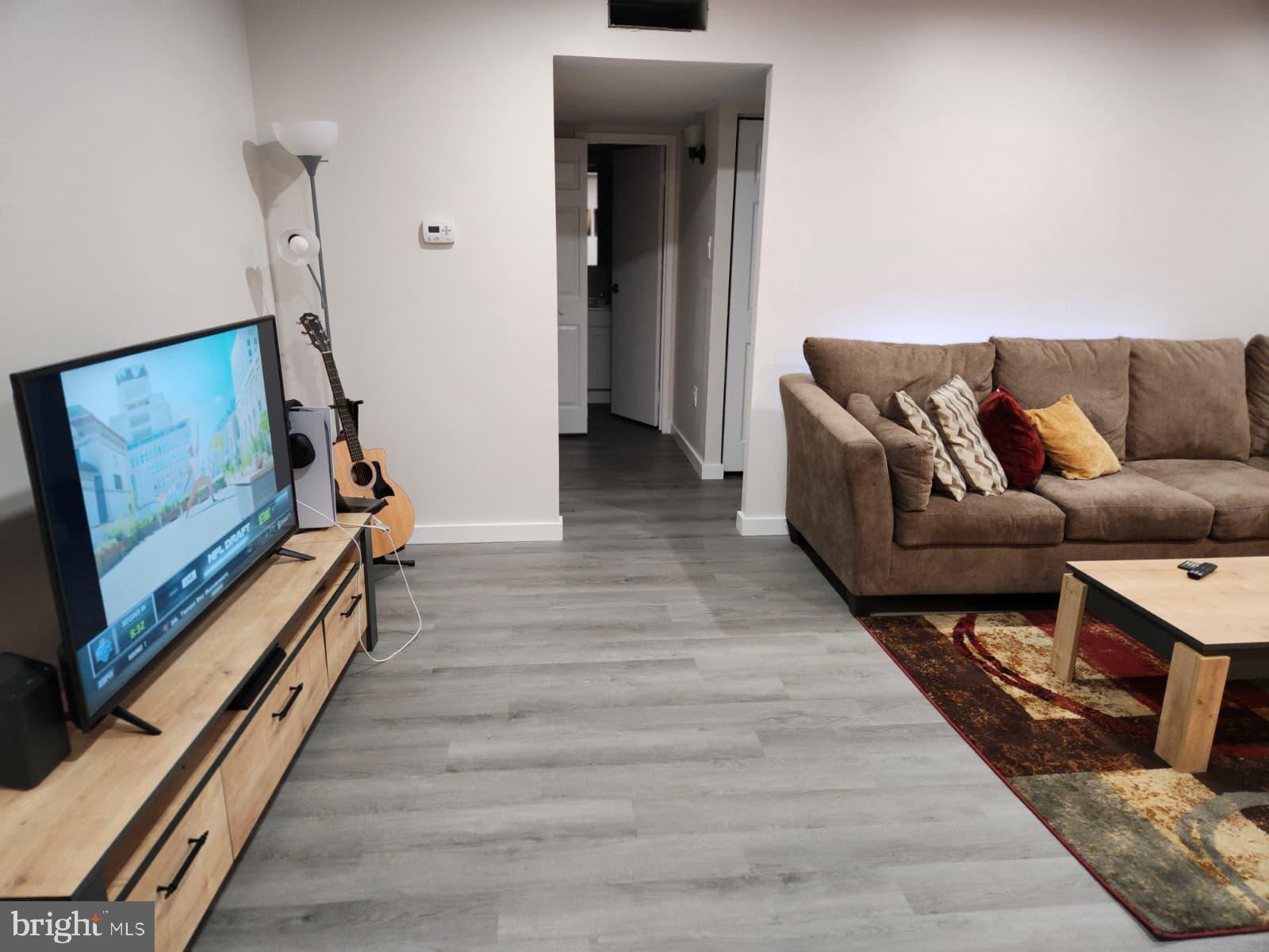 280 Bridgewater Road, Unit D10 Brookhaven, PA 19015 - Photo 6 of 12 a living room with furniture and a wooden floor