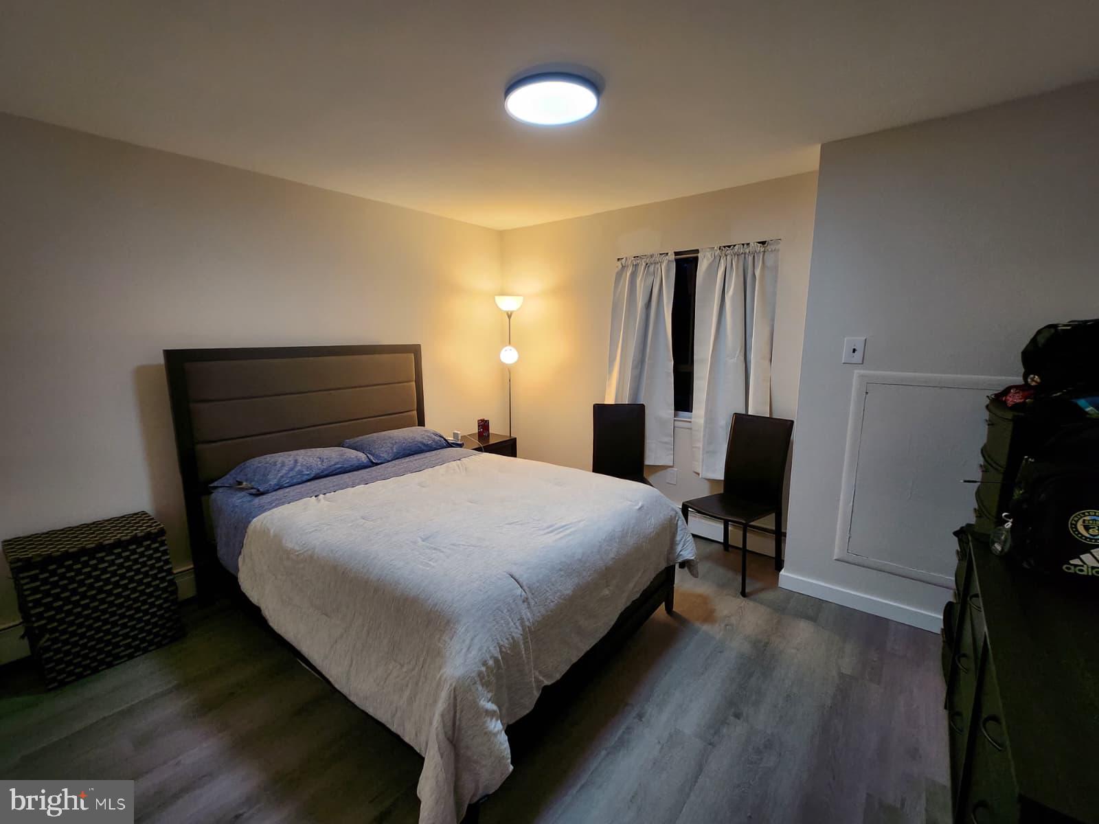 280 Bridgewater Road, Unit D10 Brookhaven, PA 19015 - Photo 7 of 12 a bedroom with a bed and wooden floor