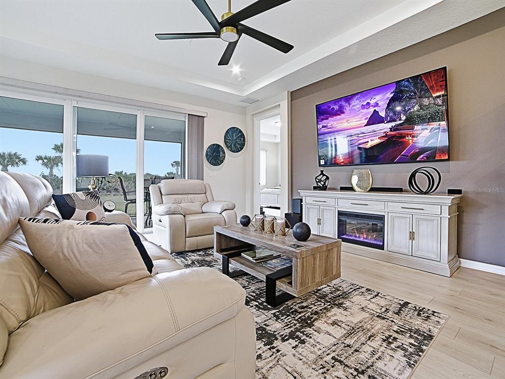 1599 Bellagio Loop Tavares, FL 32778 - Photo 16 of 75 a living room with fireplace furniture and a flat screen tv