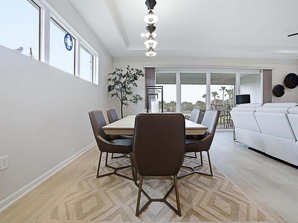 1599 Bellagio Loop Tavares, FL 32778 - Photo 17 of 75 a view of a dining room with furniture and chandelier