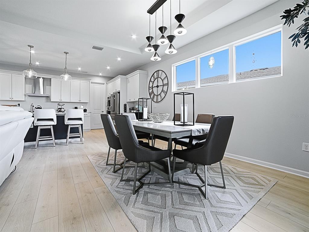 1599 Bellagio Loop Tavares, FL 32778 - Photo 19 of 75 a view of a dining room with furniture and wooden floor
