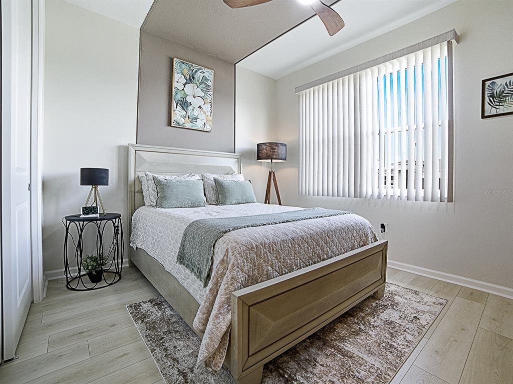 1599 Bellagio Loop Tavares, FL 32778 - Photo 20 of 75 a bed room with a bed and a chair