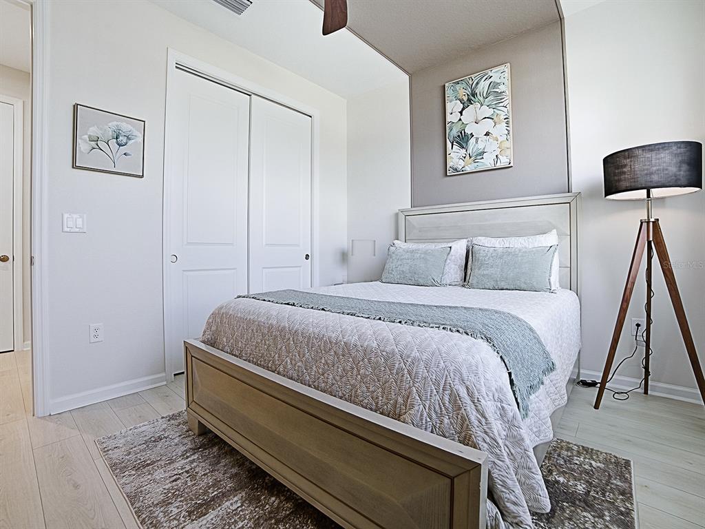 1599 Bellagio Loop Tavares, FL 32778 - Photo 21 of 75 a bedroom with a bed and painting on the wall