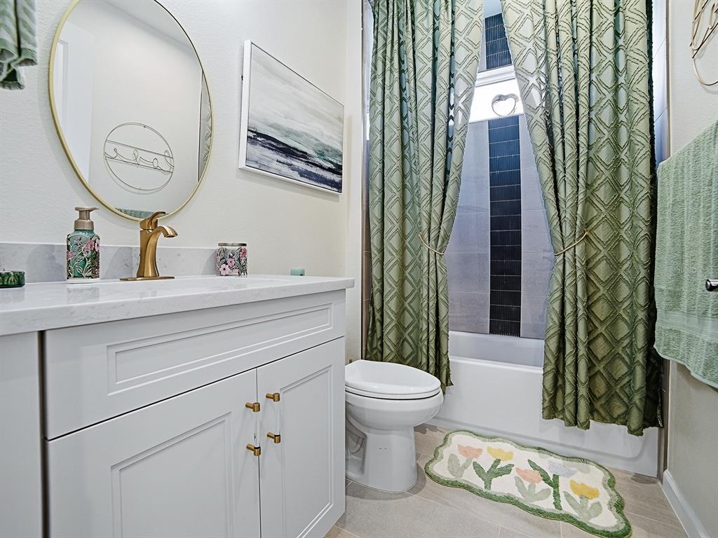 1599 Bellagio Loop Tavares, FL 32778 - Photo 23 of 75 a bathroom with a toilet a sink and a mirror