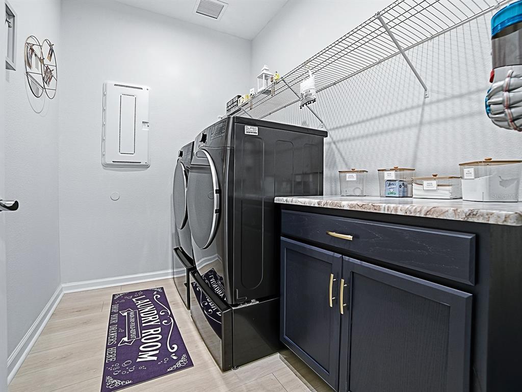 1599 Bellagio Loop Tavares, FL 32778 - Photo 24 of 75 a utility room with cabinets