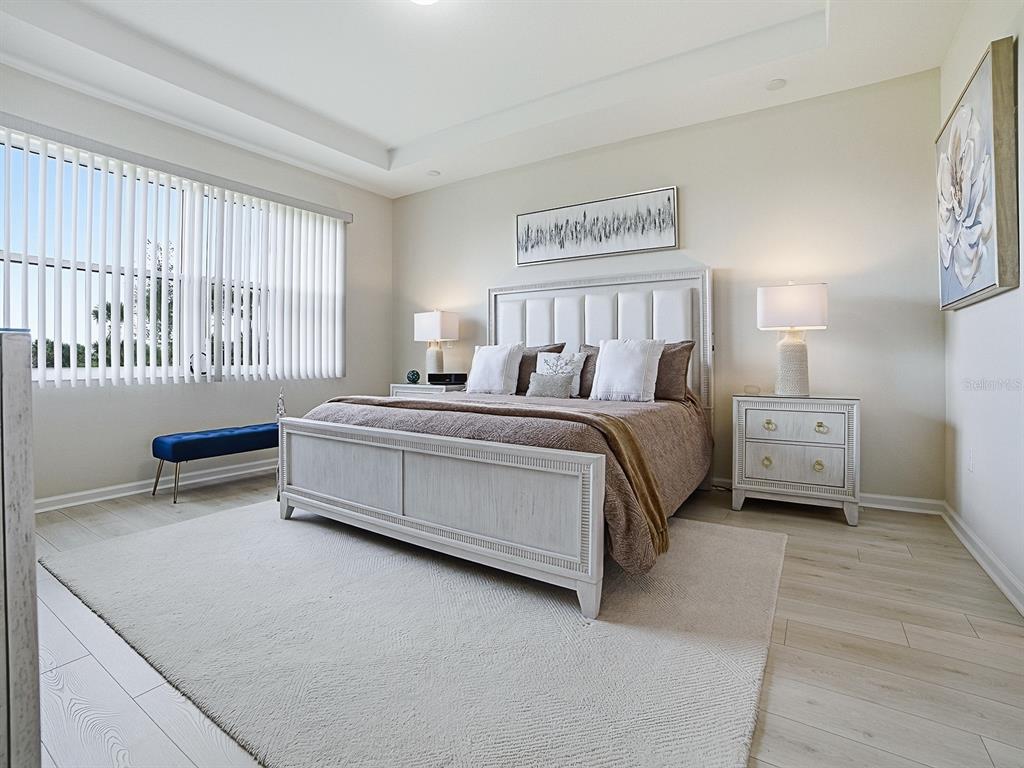 1599 Bellagio Loop Tavares, FL 32778 - Photo 25 of 75 a bedroom with a bed next to a large window