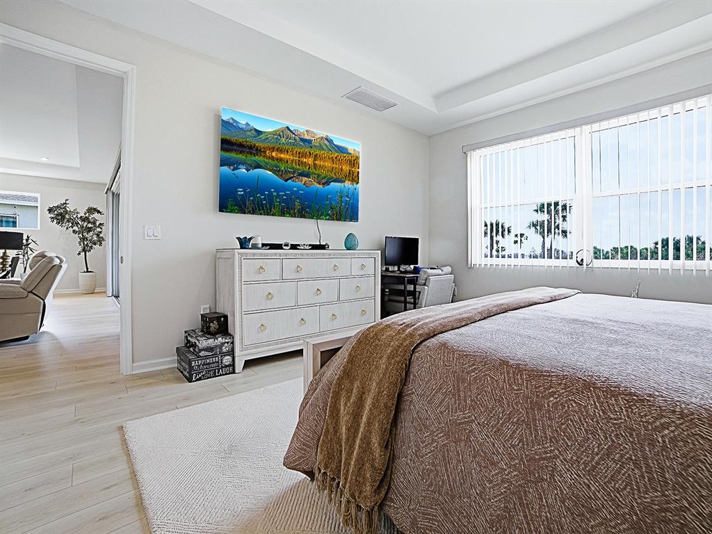 1599 Bellagio Loop Tavares, FL 32778 - Photo 28 of 75 a bedroom with a bed and a flat screen tv