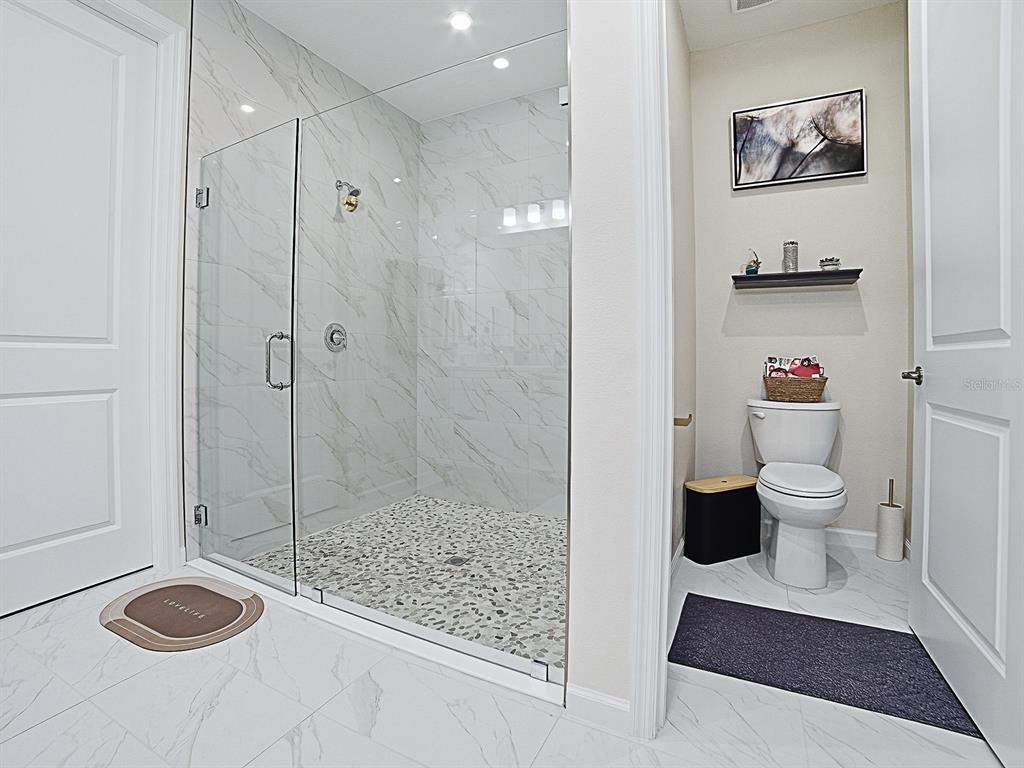 1599 Bellagio Loop Tavares, FL 32778 - Photo 30 of 75 a bathroom with a toilet and a shower