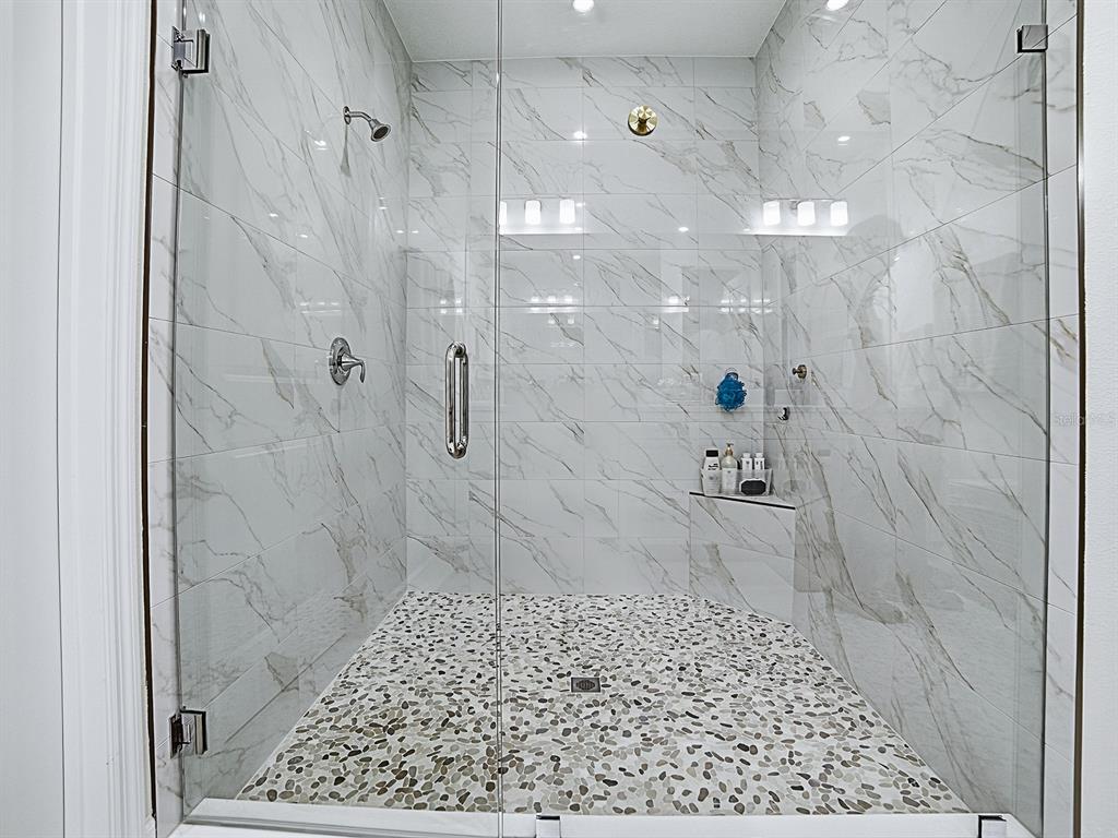 1599 Bellagio Loop Tavares, FL 32778 - Photo 31 of 75 a bathroom with a shower