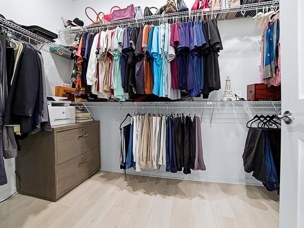 1599 Bellagio Loop Tavares, FL 32778 - Photo 32 of 75 a view of walk in closet with clothes and shoes