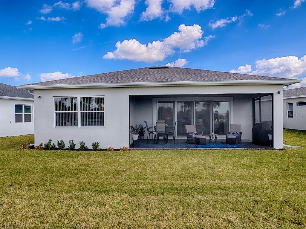 1599 Bellagio Loop Tavares, FL 32778 - Photo 36 of 75 a view of a house with swimming pool and a yard