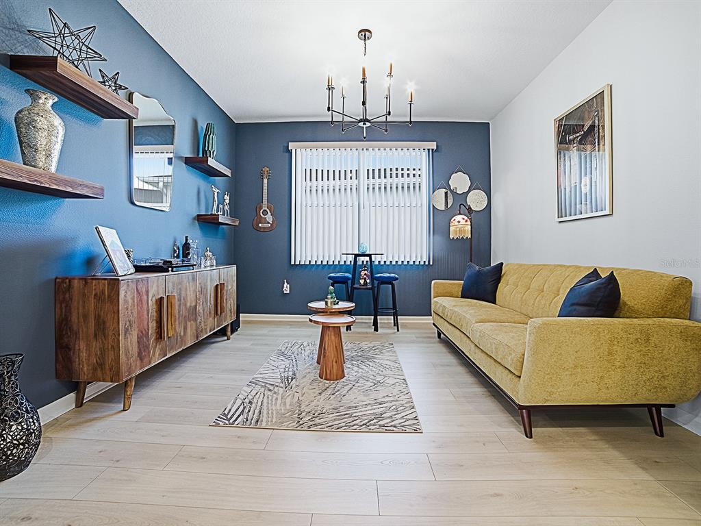 1599 Bellagio Loop Tavares, FL 32778 - Photo 5 of 75 a living room with furniture and a chandelier