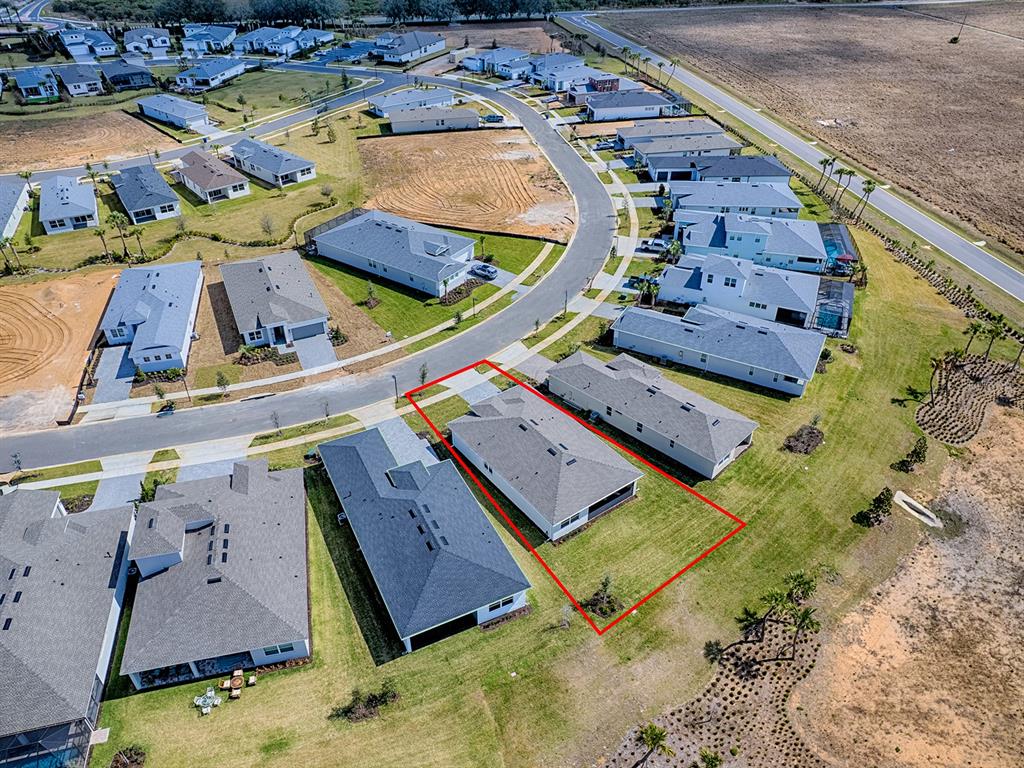 1599 Bellagio Loop Tavares, FL 32778 - Photo 52 of 75 an aerial view of a house with a yard