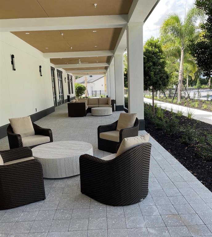 1599 Bellagio Loop Tavares, FL 32778 - Photo 71 of 75 a living room with couches and a potted plant on the wall
