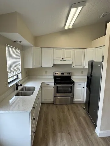 a kitchen with a refrigerator stove and sink