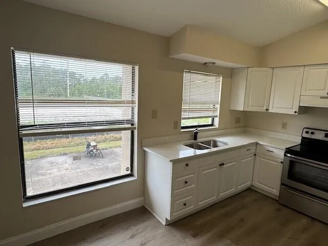 a kitchen with a sink stove and cabinets