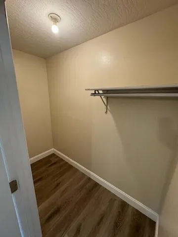 a view of a room with wooden floor