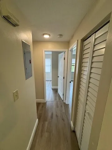 a view of a hallway with wooden floor and staircase