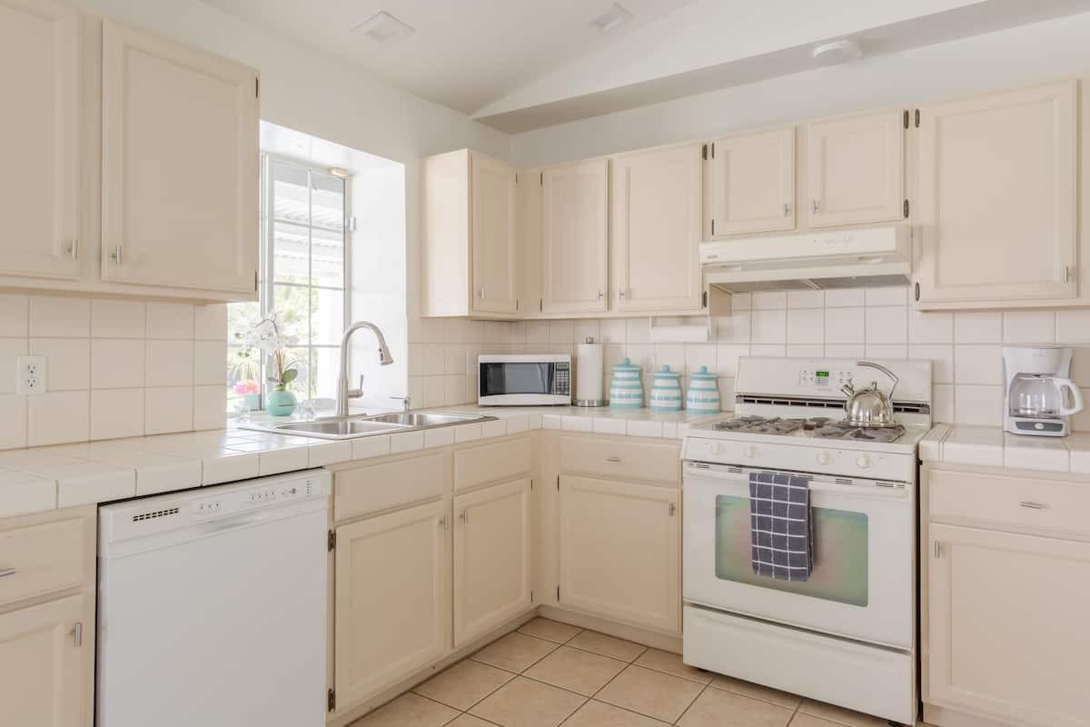 68645 Risueno Road Cathedral City, CA 92234 - Photo 11 of 17 a kitchen with cabinets appliances a sink and a window