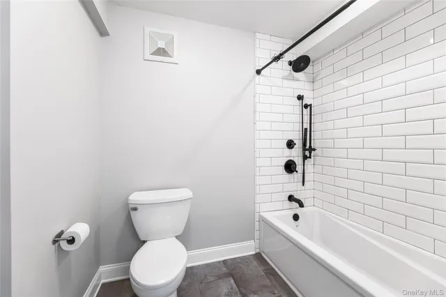 a bathroom with a toilet and a bathtub