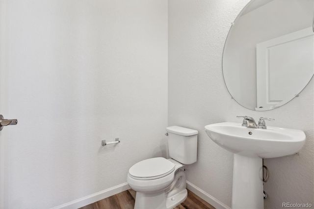 a bathroom with a sink toilet and a mirror