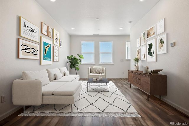 a living room with furniture and a painting on the wall