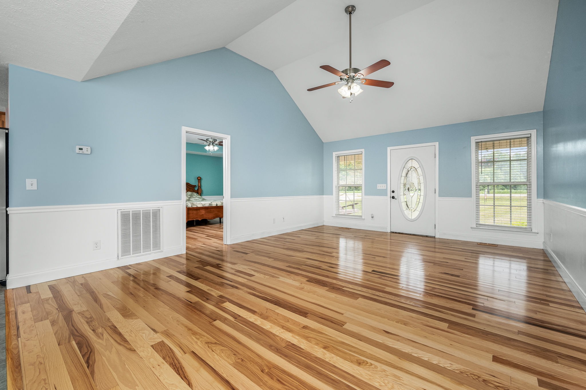 24 Shady Grove Cemetery Road Flintville, TN 37335 - Photo 17 of 40 a view of a livingroom with wooden floor a ceiling fan and windows